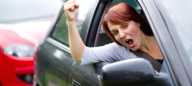 Woman gesturing out of car window
